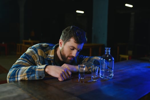 Sad man sitting at bar counter, alcohol addiction photo