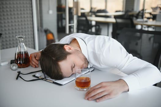 Young businessman drinking from stress photo