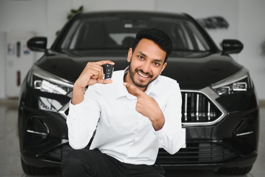 Closeup portrait happy, smiling, young man, buyer showing keys of his new car photo
