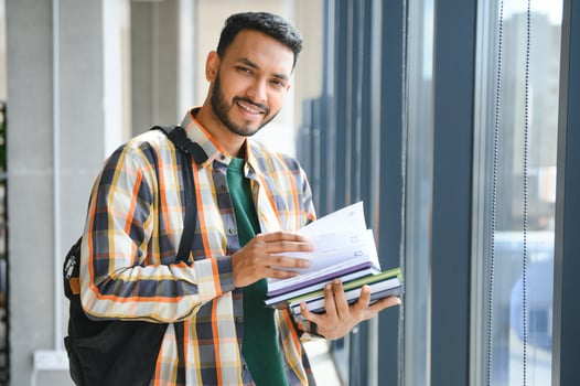 Happy indian male student at the university photo