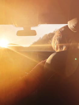 Woman in car during sunset photo