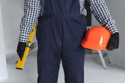Builder handyman with construction tools. House renovation background. photo