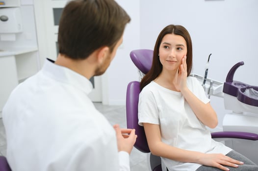 Young smiling woman with beautifiul teeth, having a dental inspection photo