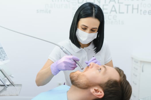 Young man at the dentist. Dental care, taking care of teeth. Picture with copy space for background. photo