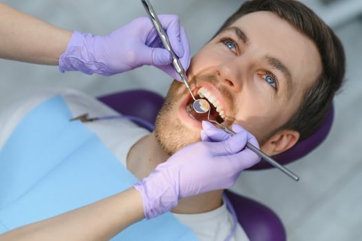 Man having teeth examined at dentists photo