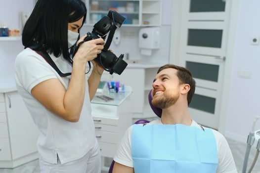 dentist clinic. A female dentist photographing her client's teeth during an appointment at the dental clinic. photo