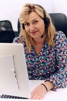 Friendly Call Center Agent Answering Incoming Calls with Headset Providing Remote Customer Service. photo