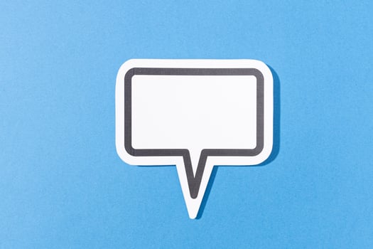 Blank Speech Bubble isolated on blue background. Mock up templateblue background photo