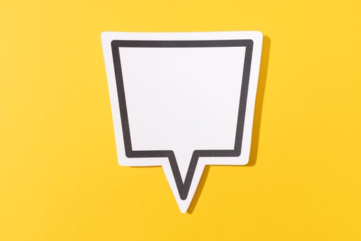 Blank Speech Bubble isolated on yellow background. Mock up template photo