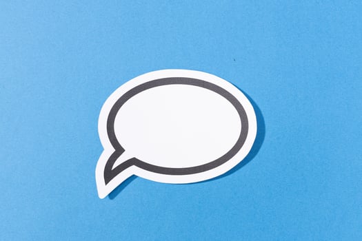 Blank Speech Bubble isolated on blue background. Mock up template photo