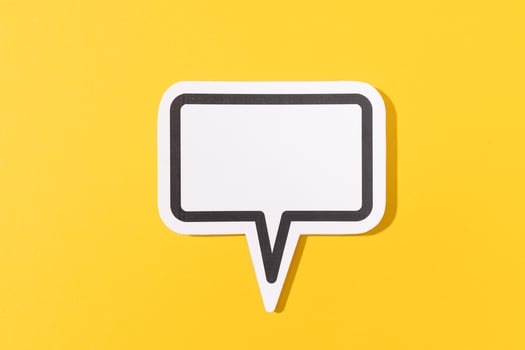 Blank Speech Bubble isolated on yellow background. Mock up template photo