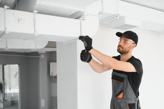 hvac technician at work. ventilation, heating system maintenance and repair photo