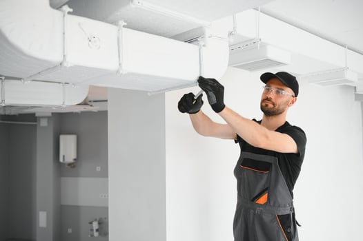 hvac services, worker install ducted pipe system for ventilation and air conditioning in house photo