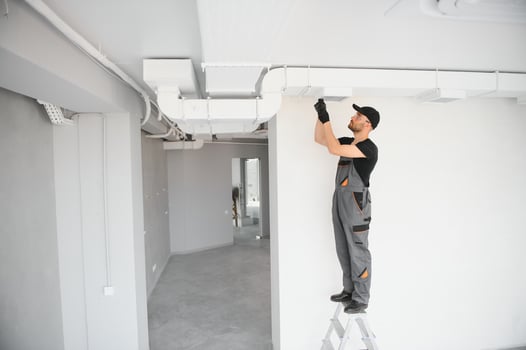 hvac services, worker install ducted pipe system for ventilation and air conditioning in house photo