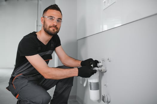 Plumber installs or change water filter. Replacement aqua filter. photo