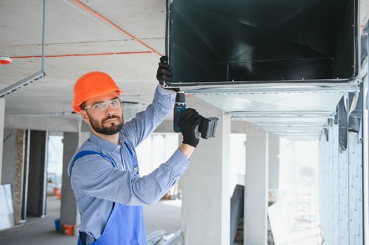hvac engineer install heat recovery ventilation system for new house. copy space photo