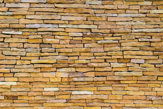 Brick wall background is a wall made of clay bricks, giving the structure strength and cement line between bricks that looks beautiful. It is popular to build a wall of ancient monuments.copy space, photo
