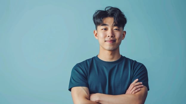 Confident Smiling Korean Man Portrait, Casual Style, Arms Crossed, Blue Background, Stock Photo for Print, Card, Poster