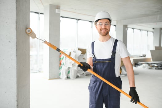 Worker renewing apartment on wall background. photo