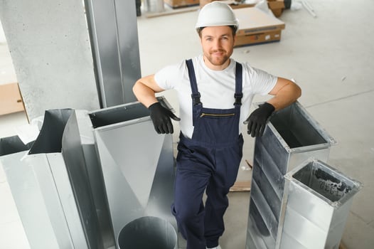 hvac services - worker install ducted pipe system for ventilation and air conditioning photo