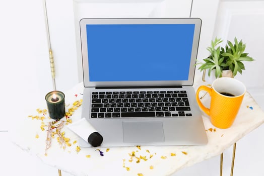 Workplace with laptop and candle photo