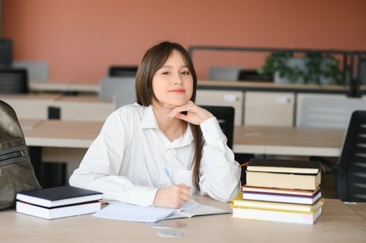 education and school concept - student girl studying and reading book at school. photo