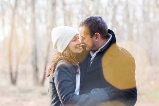 Happy couple hugging in winter park photo