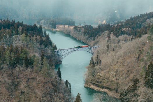 Panoramic View of Japan local train with Tadami river and bridge. Tadami Railway Line in The Valley at Mishima Machi, Aizu, Fukushima Prefecture, Japan. Landmark and iconic spot for tourist attraction photo