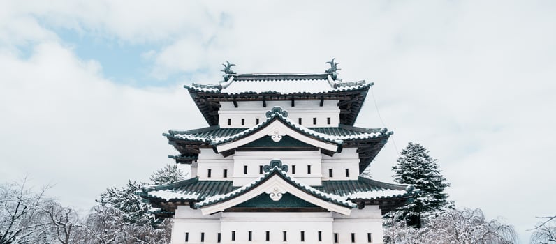 White Hirosaki Castle or Takaoka Castle with snow in winter, hirayama style Japanese castle located in Hirosaki city, Aomori Prefecture, Tohoku, Japan. Landmark for tourist attraction. Japan travel photo
