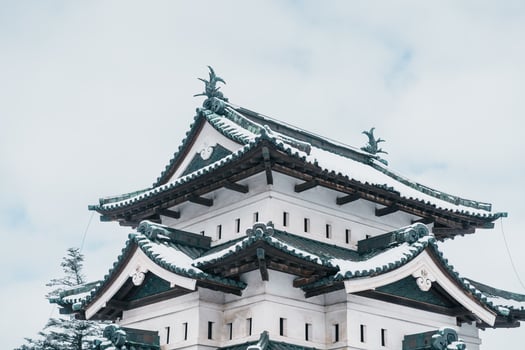 White Hirosaki Castle or Takaoka Castle with snow in winter, hirayama style Japanese castle located in Hirosaki city, Aomori Prefecture, Tohoku, Japan. Landmark for tourist attraction. Japan travel photo