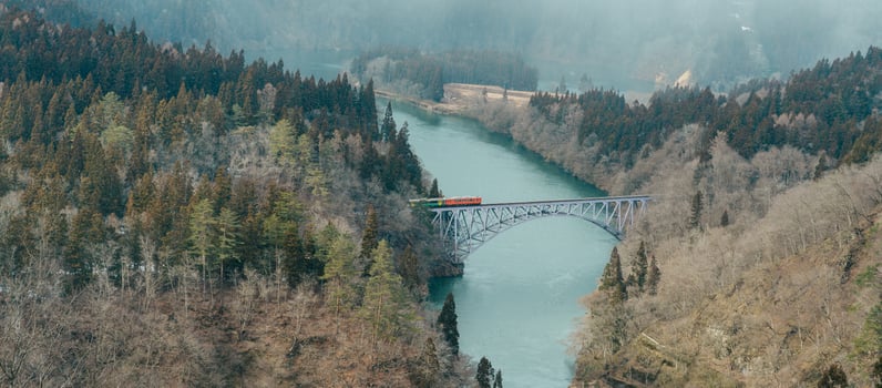 Panoramic View of Japan local train with Tadami river and bridge. Tadami Railway Line in The Valley at Mishima Machi, Aizu, Fukushima Prefecture, Japan. Landmark and iconic spot for tourist attraction photo