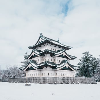 White Hirosaki Castle or Takaoka Castle with snow in winter, hirayama style Japanese castle located in Hirosaki city, Aomori Prefecture, Tohoku, Japan. Landmark for tourist attraction. Japan travel photo