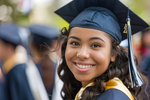 A young graduate in cap and gown photo