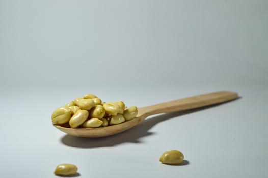 Fried peanuts. Served in a transparent jar. Selective focus photo