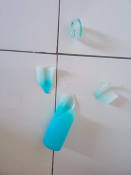 a glass bottle that broke when it fell photo