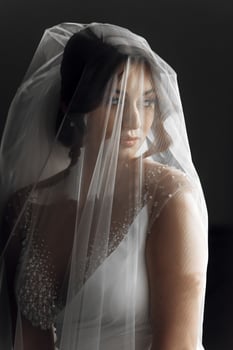 A woman is wearing a veil with a pattern of zigzags photo
