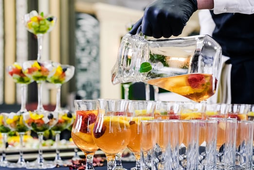 Bartender Pouring Fruit Punch into Glasses photo
