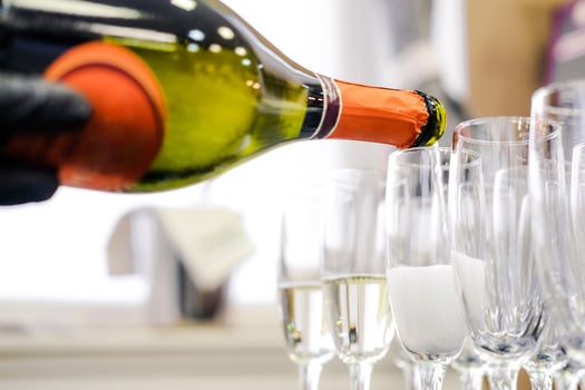 Pouring Champagne into Flutes at Event photo