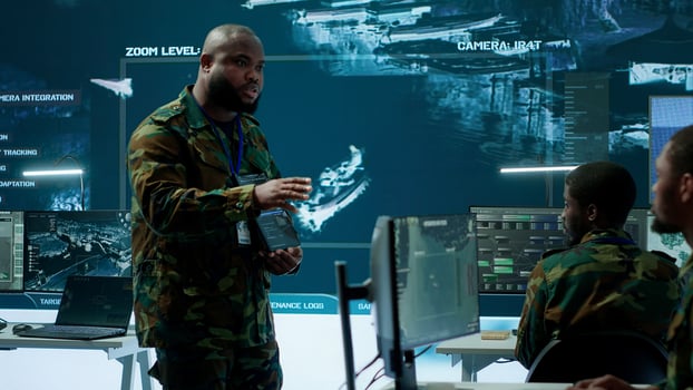 Military officer leads cybersecurity efforts in a high tech control center, ensuring data protection and managing surveillance systems, Coordinating national security operations. Camera A. photo