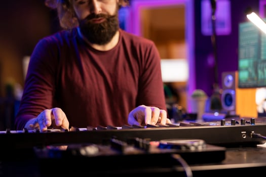 Audio engineer pressing keys of electric synthesizer and composing new song, adjusting volume level. Singer composer producing music on electronic piano midi controller, mixing console. photo