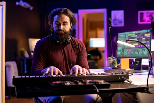 Skilled producer creating new music on piano midi controller, working with mixing console and daw software interface on pc. Musician artist singing at microphone and mastering acoustical tunes. photo