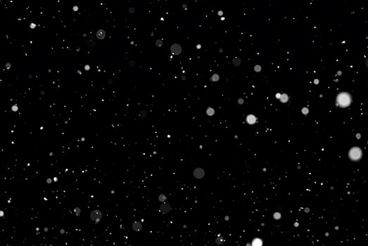 White Snow Bokeh on Black Background - Snowfall Design Element photo
