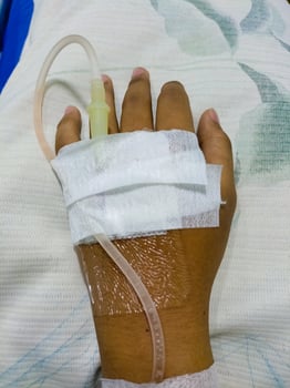 Asian man in hospital with intravenous saline. hand is being infused, infected with the virus, are lying and being treated in beds in hospitals. photo