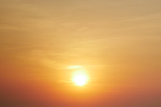 Stunning Golden Sunset with Warm Orange and Yellow Hues in a Clear Sky photo