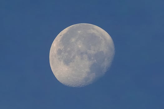 Full moon over blue sky photo