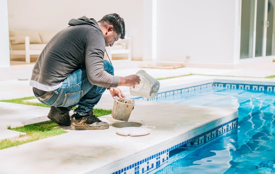 Person cleaning garbage filter basket for swimming pool. Man cleaning swimming pool filter basket photo