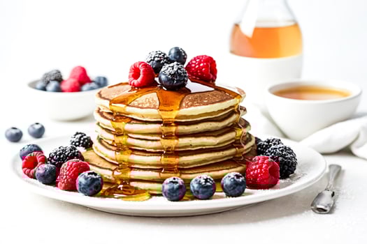 Delicious Pancakes with Berries and Syrup photo