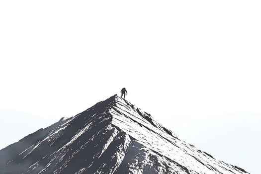 Silhouette of a Person Standing on a Mountain Peak photo