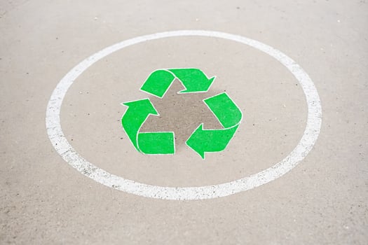 Green Recycle Symbol Painted on Concrete photo