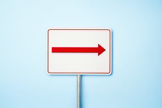 Red Arrow Sign on Blue Background photo